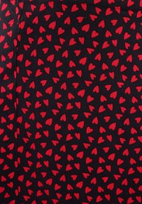 Black fabric featuring a repeated pattern of small red hearts, evenly spaced, with a smooth texture.