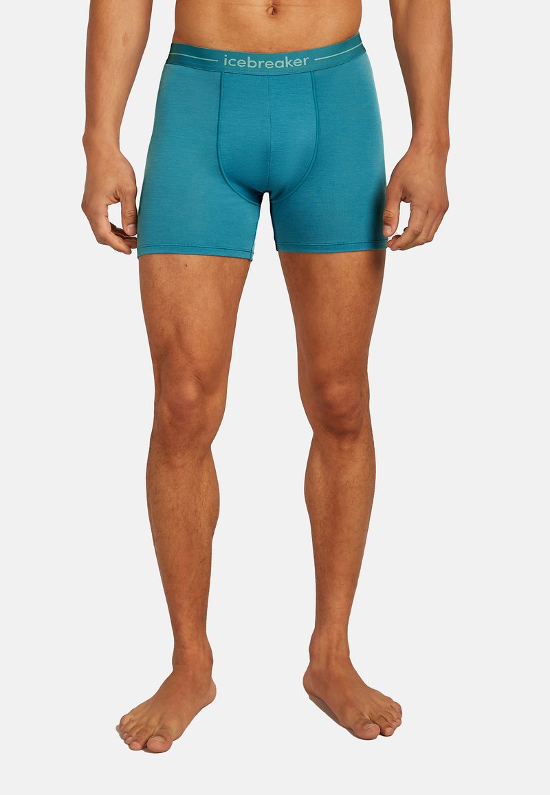 Herrens teal boxertrosor tillverkade av mjukt material. Har en åtsittande passform, en frontficka och en kontrasterande grå midjeband med "icebreaker"-logotyp.