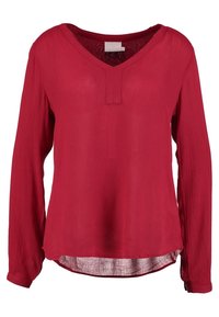 Blusa rossa a maniche lunghe realizzata in tessuto testurizzato con scollatura a V e una leggera apertura sul davanti, caratterizzata da un orlo curvo.
