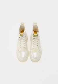 White high-top sneakers featuring an iridescent toe cap, textured surface, lace-up design, and a contrasting yellow inner lining.