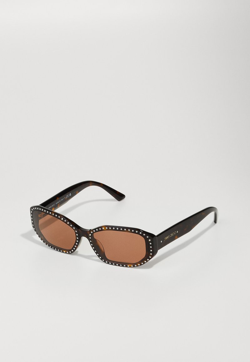 Brown-tinted sunglasses with a square shape, tortoiseshell frame, and white decorative studs along the edges.
