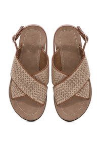 Brown slingback sandals with woven textile cross straps, cushioned insoles, and adjustable buckle closure. Flat sole design.