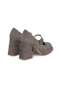 Zapatos de tacón alto de ante gris con punta redondeada, correa en el tobillo y una hebilla decorativa de cristal. Diseño de tacón grueso y cuadrado.
