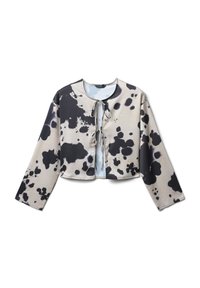 Blusa cropped a maniche lunghe con motivo astratto a macchie nere e beige, dotata di due lacci davanti al collo e al petto.