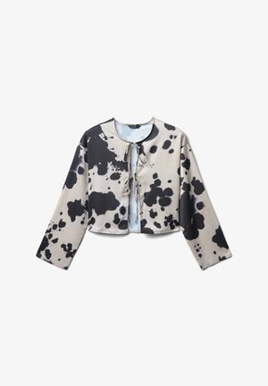 Blouse cropped à manches longues avec un motif éclaboussé abstrait noir et beige, dotée de deux liens à l'avant au niveau du cou et de la poitrine.