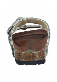 Faux fur slide sandal with two adjustable straps, brown cork footbed, textured black rubber sole, and a green logo detail inside.