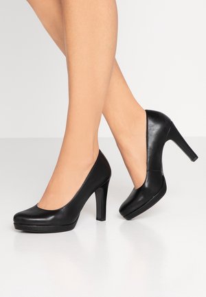 Sorte læder højhælede sko med en rund tå, glat overflade og platformdesign, der har en høj stilettohæl og minimale detaljer.