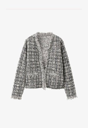 Cardigan en tweed noir et blanc à la coupe ample, bords effilochés et deux poches avant. Motif à carreaux sur tout le tissu.