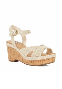 Beige woven platform sandals with a cork wedge heel, featuring crossed straps and an adjustable ankle buckle for secure fit.