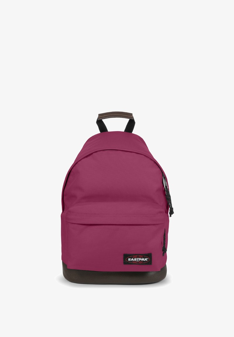 Red and pink fabric backpack with a rounded shape, black bottom, and brown top handle. Features a front zip pocket and logo on the side.