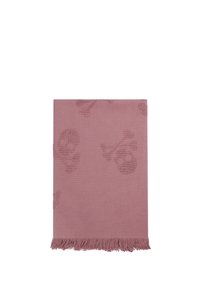 Couverture tissée rose avec un motif texturé de skulls et de tibias, dotée de bords à franges. Le tissu doux offre une apparence chaleureuse.