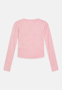 T-shirt à manches longues en rose clair, avec une texture côtelée et un col rond. Le tissu est doux et extensible, conçu pour un ajustement près du corps.