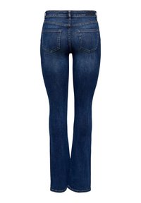 Jean en denim bleu foncé avec un design à jambe évasée, comportant deux poches arrière et une taille lisse. Le tissu présente une légère texture et une variation de couleur.
