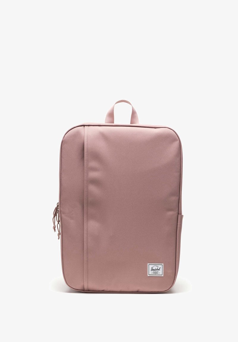 Mochila para portátil de color rosa con una tela suave y texturizada, forma delgada, asa en la parte superior y bolsillo lateral. Tiene una pequeña etiqueta de la marca en el frente.