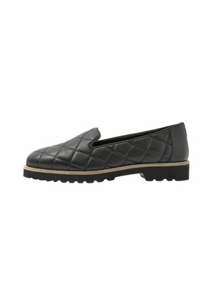 Chaussure noire en cuir matelassé, à enfiler, avec une bordure beige et une semelle épaisse en caoutchouc noir, vue de côté sur fond blanc.
