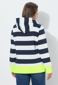 Sudadera con capucha a rayas azul marino y blancas, con un dobladillo amarillo verdoso, que incluye capucha y mangas largas, hecha de un material suave.