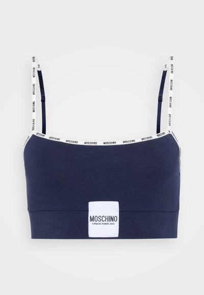 Bralette blu navy realizzato in morbido cotone, con spalline regolabili e dettaglio del logo, e una patch bianca con il marchio sulla cintura anteriore.