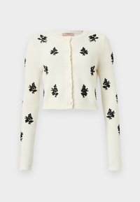 Cardigan bianco lavorato a maglia con ricami floreali neri, maniche lunghe, vestibilità corta e patta dei bottoni con ruches.