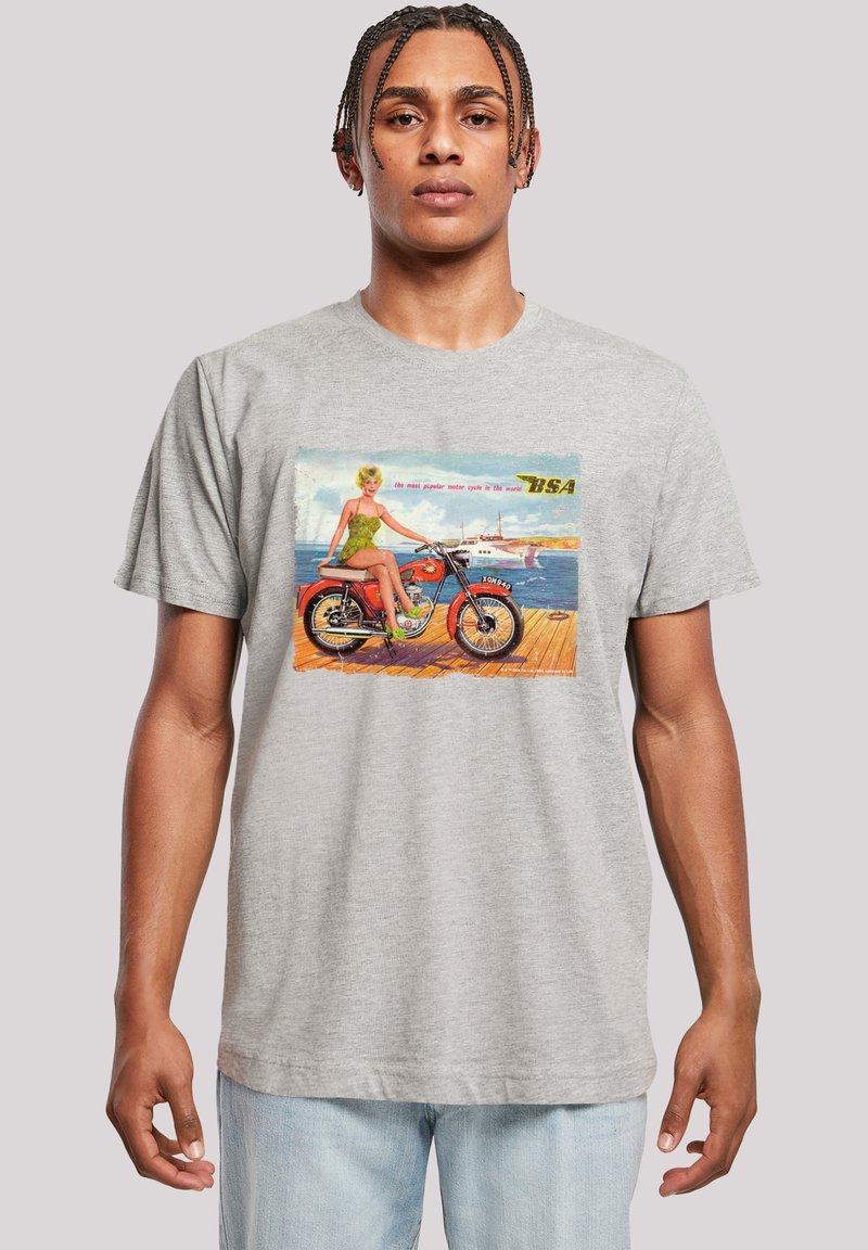 Gray cotton t-shirt featuring a vintage print of a woman on a motorcycle, with green accents and colorful background details.
