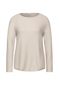 Jasnobeżowa bluzka z długim rękawem i zaokrąglonym dekoltem, wykonana z miękkiego materiału. Posiada rękawy raglanowe i zaokrąglony dół.