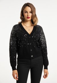 Cardigan nero con scollo a V, chiusura a sei bottoni e paillettes argentate sparse sulle maniche e sulla parte superiore per un design testurizzato.