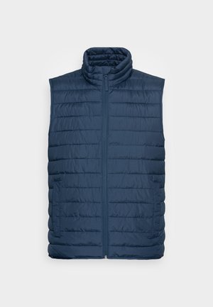 Veste matelassée sans manches bleu marine avec fermeture éclair devant et deux poches latérales, col montant, présentée sur fond clair.