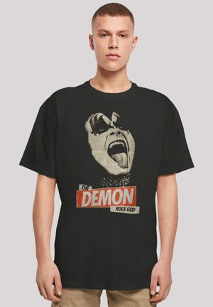 Black cotton t-shirt featuring a bold graphic print of a face with facial paint, accompanied by the text "THE DEMON ROCK GOD" in red and white.