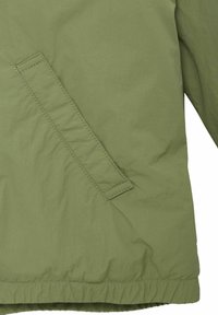 Lekka, oliwkowa kurtka o gładkiej fakturze, z ukośną boczną kieszenią i elastycznym mankietem, charakteryzująca się minimalizmem w designie.