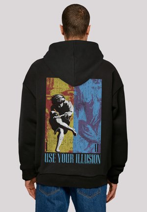 Black hoodie featuring a large graphic design on the back with a figure in motion, vibrant red, yellow, and blue blocks, and "USE YOUR ILLUSION" text.