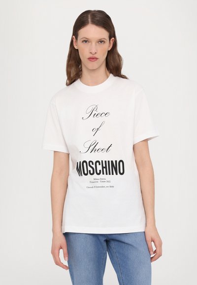 White cotton t-shirt featuring black text reading “Piece of Sheet MOSCHINO” in bold, with additional smaller text below. Casual fit.