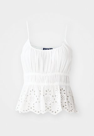 Bílá bavlněná tílko s nastavitelnými ramínky, nařaseným živůtkem a volánovým lemem s vyšitými květinovými výřezy.