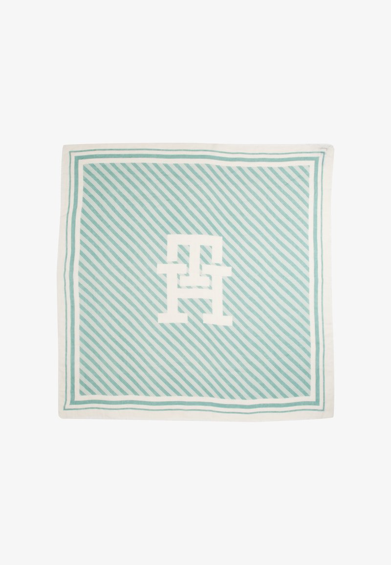 Cotton square blanket features a light aqua background with white diagonal stripes and a large white logo in the center, framed by a solid border.