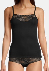 Black camisole with lace trim along the neckline and hem. Adjustable straps, snug fit, and soft fabric. Lace features floral patterns.