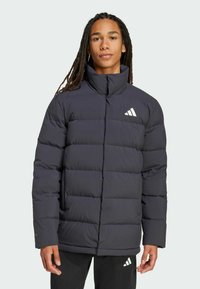 Navy puffer jacket with a high collar and quilted design. Features a white logo and soft texture, providing warmth and comfort.