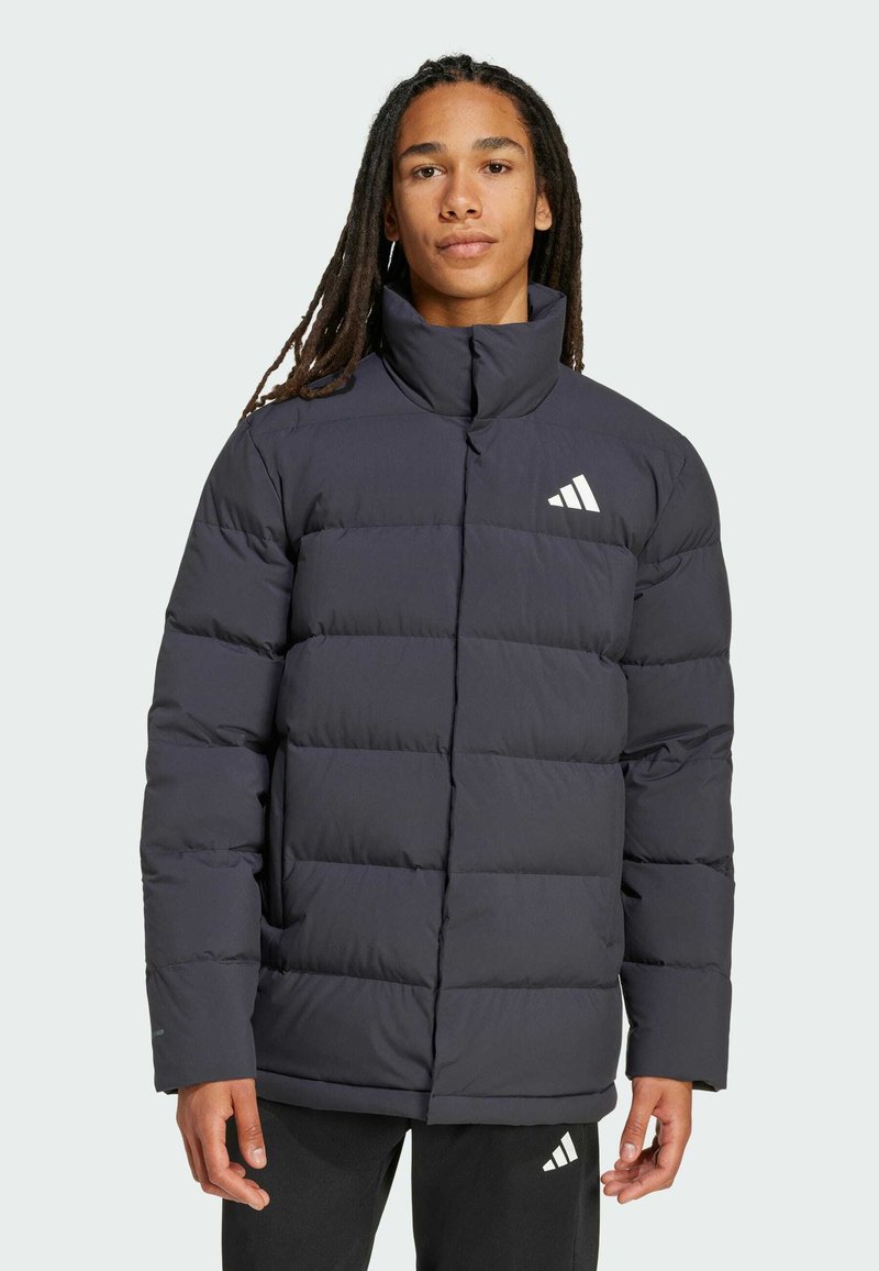 Navy puffer jacket with a high collar and quilted design. Features a white logo and soft texture, providing warmth and comfort.