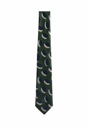 Green tie featuring a pattern of alternating navy blue and white circles. Made from smooth fabric with a narrow, pointed end design.