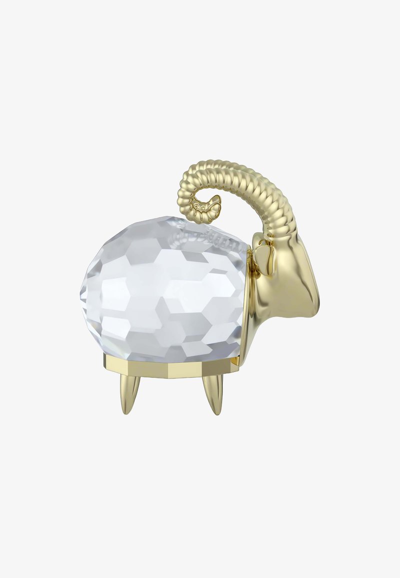 Figurkę owieczki z kryształu o oszlifowanej, przezroczystej powierzchni i złotych akcentach, z zawiniętymi rogami i trzema złotymi nogami.
