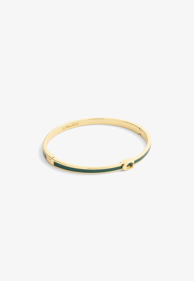 Złoty bransoletka bangle z zielonym emaliowanym paskiem, minimalistyczny design oraz grawerowany logo. Obecny jest okrągły detal akcentujący.