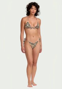 Ensemble de bikini floral noir, comprenant un haut triangulaire avec des bretelles fines et un bas taille basse avec des liens réglables sur les côtés.