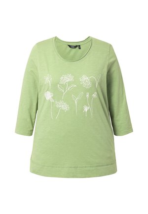 Maglietta verde chiaro a maniche lunghe con collo rotondo e disegni floreali stilizzati bianchi sul petto.
