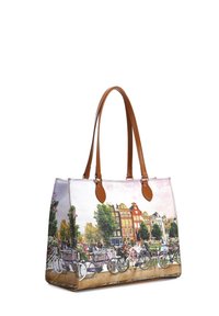 Borsa a spalla con manici in pelle marrone, caratterizzata da un design stampato di edifici e biciclette, predominantemente in colori pastello.