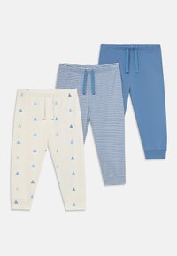 Trois paires de pantalons pour enfants : crème avec des motifs de tracteurs bleus, rayures bleues et blanches, uni bleu. Tous présentent des ceintures élastiques et des poignets.