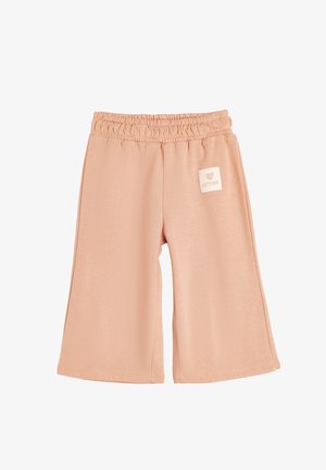 Shorts de algodón color durazno con cintura elástica, piernas amplias y una etiqueta rectangular que presenta un corazón y el texto "Chica Linda."