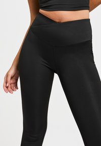 Zwarte hoge taille legging van soepel, rekbaar materiaal. Heeft een brede tailleband en naadloos ontwerp voor comfort en een goede pasvorm.