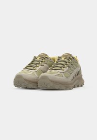Light green hiking shoes with mesh and suede materials, textured soles, and reinforced accents. Laces are in a matching hue.