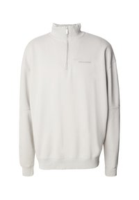 Krémově bílá mikina s čtvrtým zipem, s vysokým límcem, žebrovanými manžetami a lemem a nenápadným logem "PEGADOR" na levé straně hrudi.