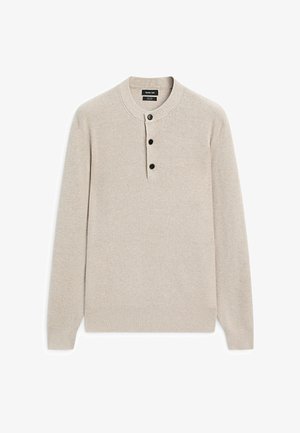 Béžový žebrovaný pletený svetr s dlouhými rukávy a kulatým výstřihem, který má rozparek se třemi knoflíky.