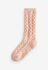 Kabelstickad socka i mjuk rosa tyg. Har ett upphöjt flätemönster, ribbat ben och förstärkt tå. Tjock textur för värme.