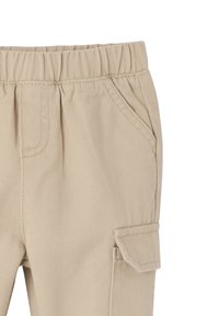 Beige Cargo-Hosen mit einem elastischen Bund, Seitentaschen und einer aufgesetzten Tasche am Oberschenkel. Hergestellt aus strapazierfähigem Stoff mit einer glatten Textur.