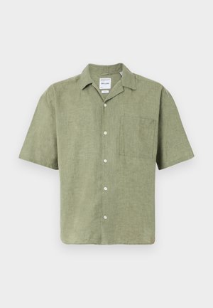 Short-sleeve olive green linen shirt with a collar, front button closure, and a chest pocket. Textured fabric with a natural finish.